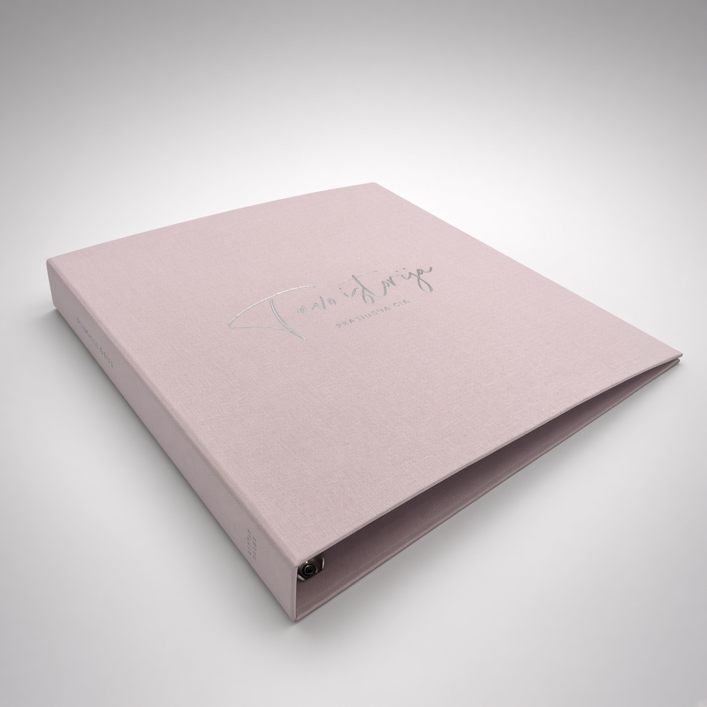 Pink fabric-covered ring binder with silver foil lettering