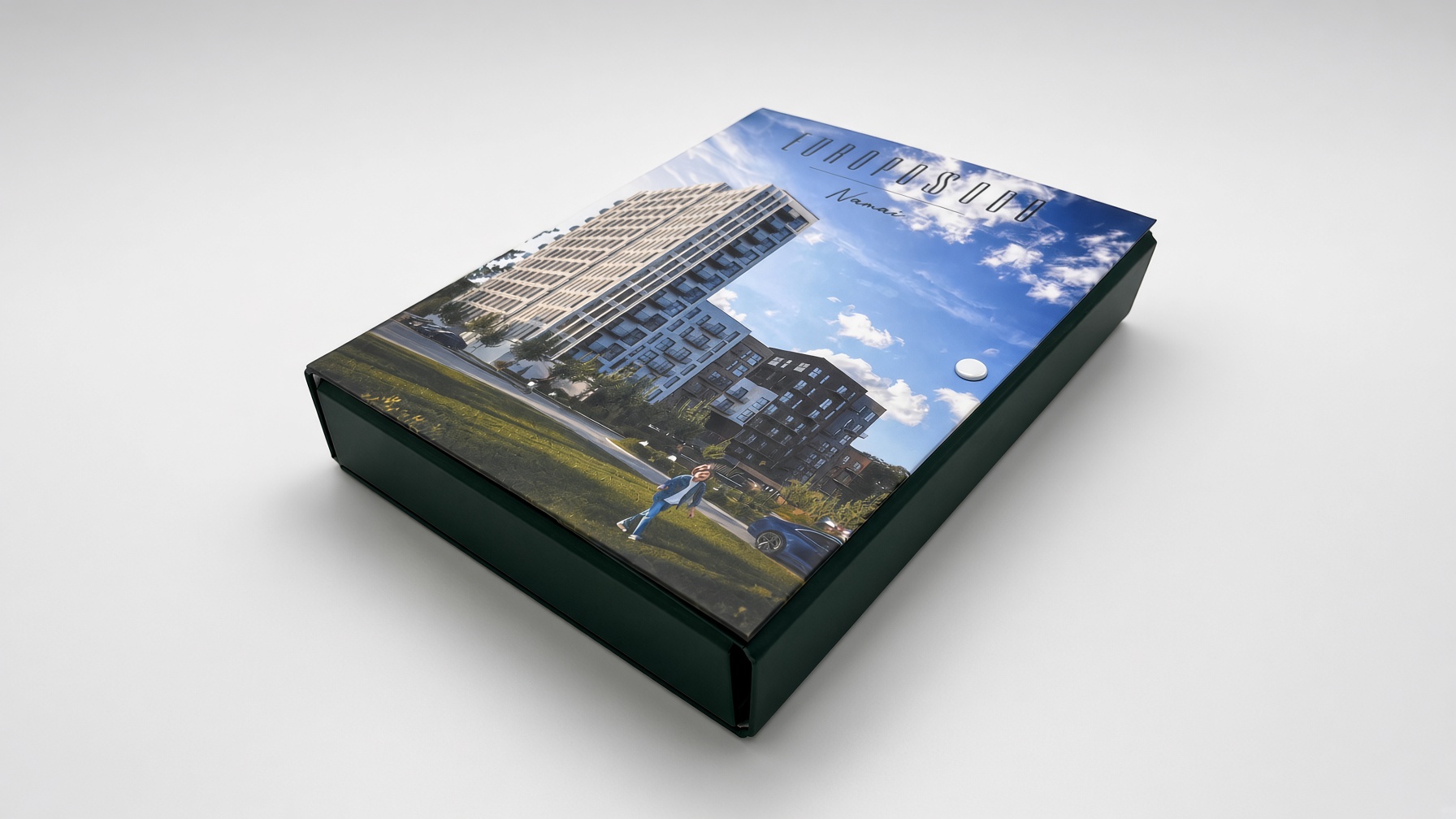Dark green hinged box with a colour photo of apartment buildings on the lid